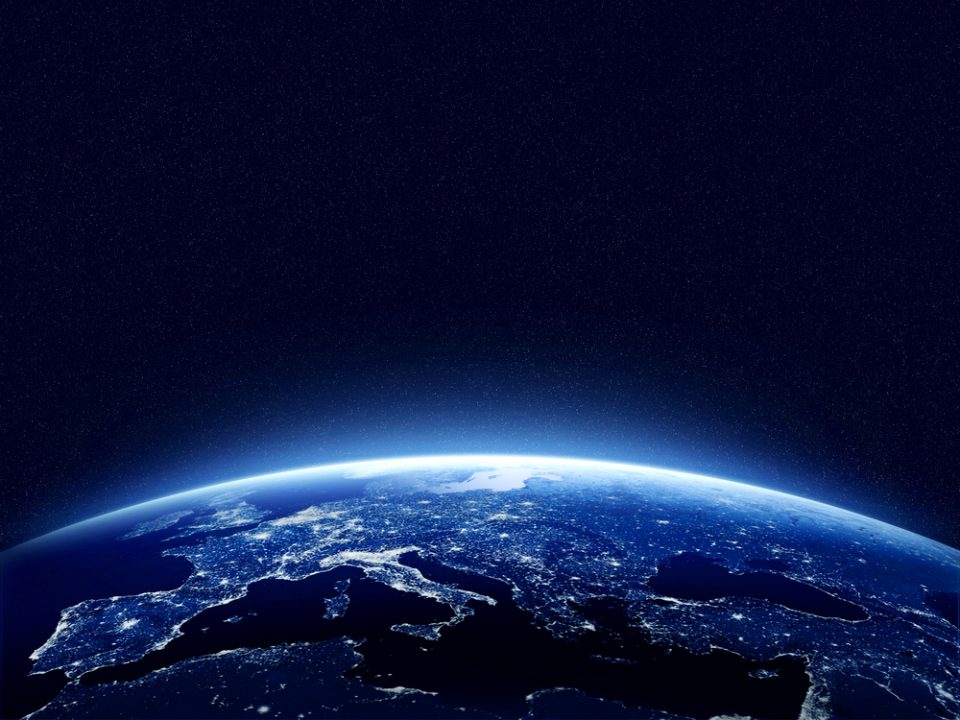 Earth at night as seen from space with blue, glowing atmosphere and space at the top. Perfect for illustrations. Elements of this image furnished by NASA